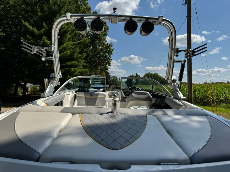 Slide: The Image of 2012 MasterCraft X-15 boat with sleek interior and wakeboard tower under a clear sky. - 14