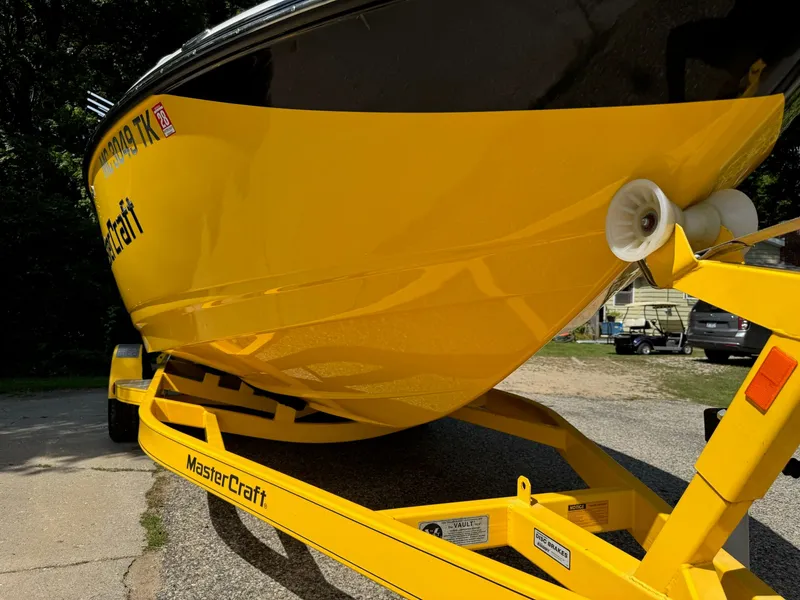 Slide: The Image of Yellow 2012 MasterCraft X-15 boat on trailer, parked outdoors. - 5