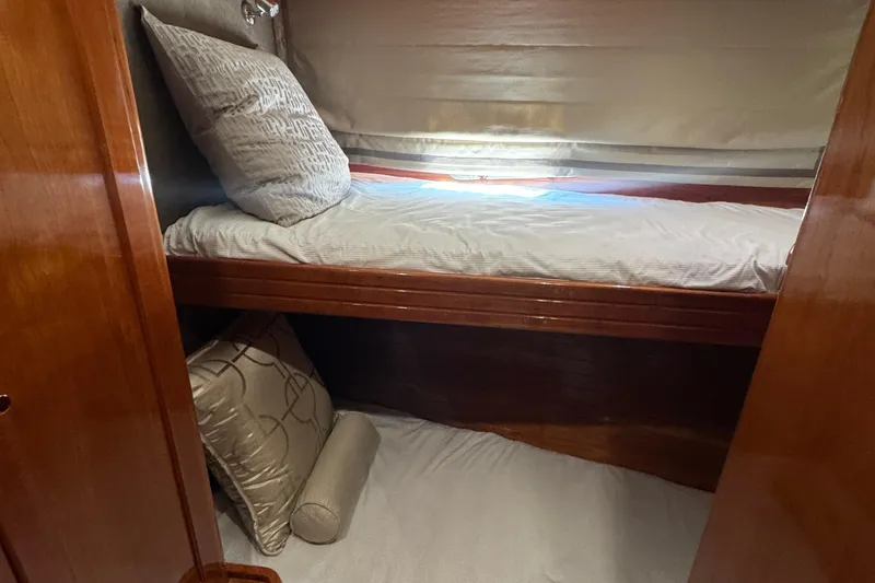 Slide: The Image of Cozy cabin interior of 1999 McKinna 57 Pilothouse with wooden bunk beds and pillows. - 195