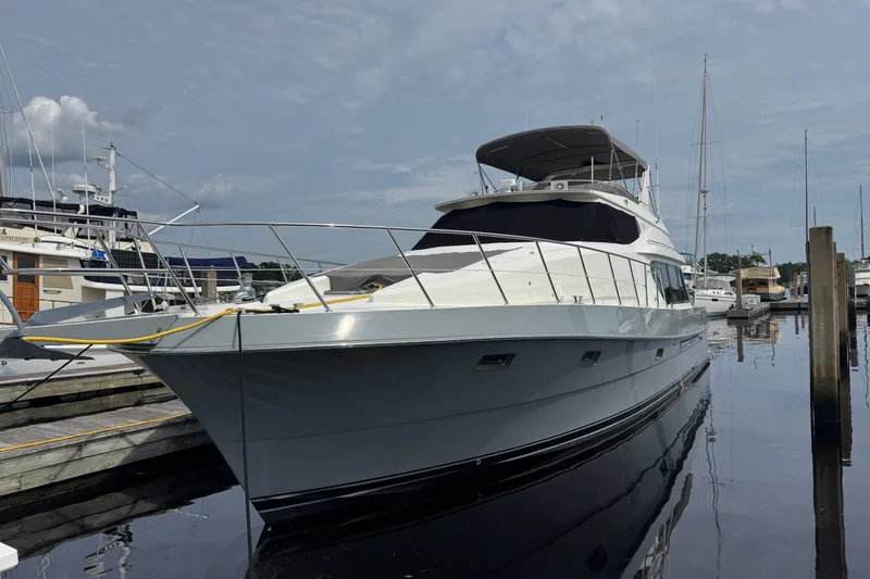 Slide: The Image of 1999 McKinna 57 Pilothouse yacht docked at marina under cloudy sky. - 201