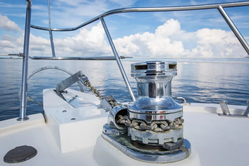 Slide: The Image of Anchor winch on 1999 McKinna 57 Pilothouse yacht, calm sea and cloudy sky. - 33