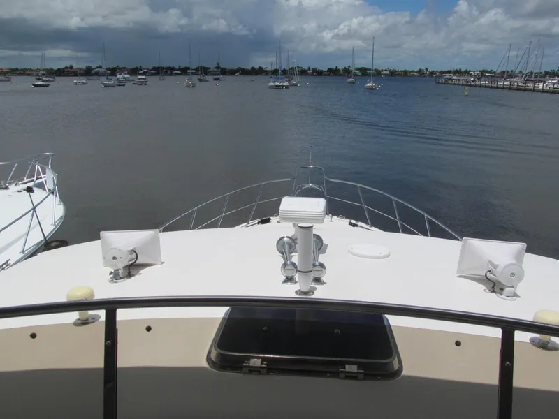 Slide: The Image of 1999 McKinna 57 Pilothouse yacht on calm waters with cloudy sky. - 35