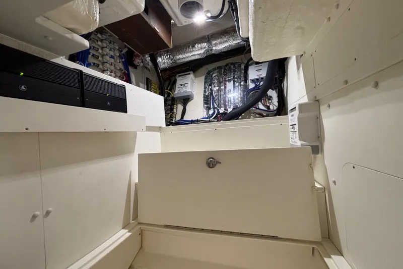 Slide: The Image of 2024 Pursuit OS 445 Offshore engine room with electrical systems and wiring. - 118