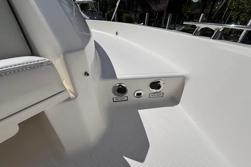 Slide: The Image of 2024 Pursuit OS 445 Offshore boat deck with raw and fresh water controls. - 121