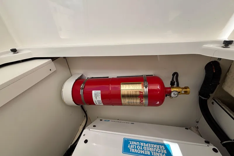 Slide: The Image of 2024 Pursuit OS 445 Offshore boat interior with mounted fire extinguisher. - 124