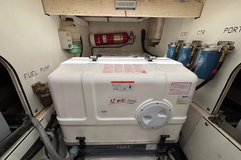 Slide: The Image of Engine room of 2024 Pursuit OS 445 Offshore with generator and fuel system components. - 126