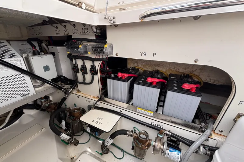 Slide: The Image of 2024 Pursuit OS 445 Offshore boat engine compartment with batteries and wiring. - 128