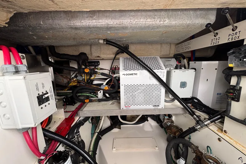 Slide: The Image of Engine compartment of 2024 Pursuit OS 445 Offshore boat with Dometic equipment and wiring. - 129