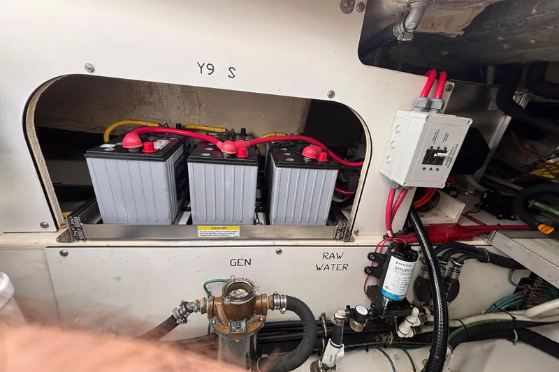 Slide: The Image of 2024 Pursuit OS 445 Offshore boat engine compartment with batteries and wiring. - 131