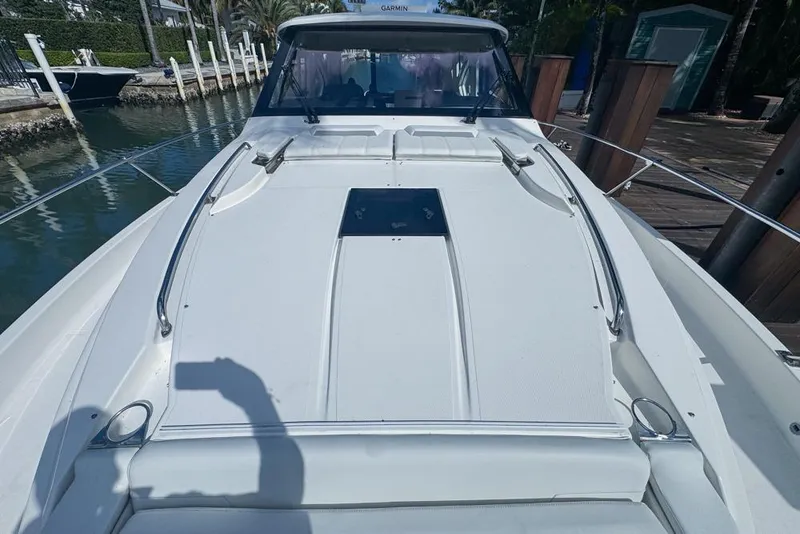 Slide: The Image of 2024 Pursuit OS 445 Offshore boat deck, docked in a marina. - 132