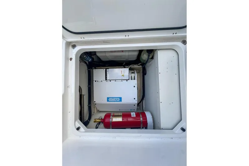 Slide: The Image of 2024 Pursuit OS 445 Offshore engine compartment with fire extinguisher and equipment. - 139