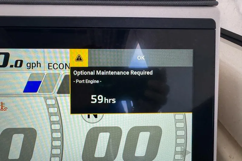 Slide: The Image of Display screen showing maintenance alert for 2024 Pursuit OS 445 Offshore port engine. - 140