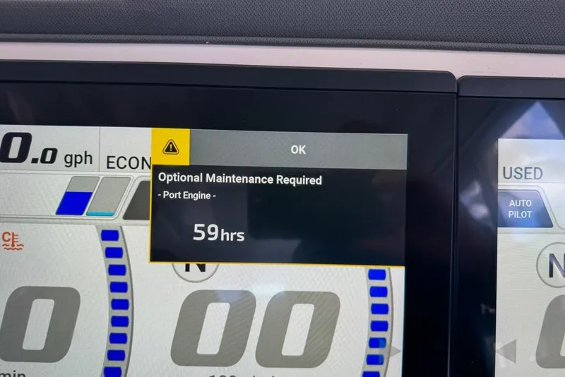 Slide: The Image of Display screen showing maintenance alert for Pursuit OS 445 Offshore, 2024 model, port engine. - 141