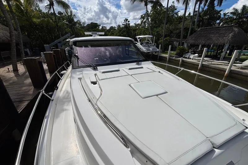 Slide: The Image of 2024 Pursuit OS 445 Offshore boat docked, showcasing sleek white deck design. - 17