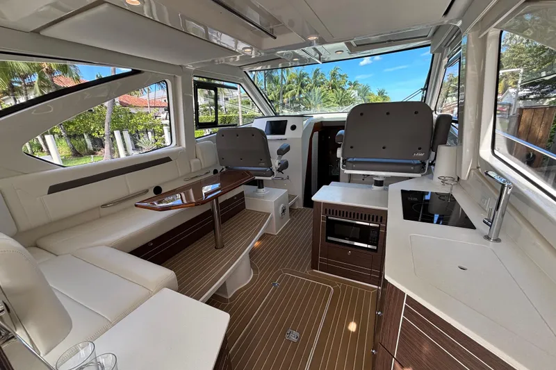 Slide: The Image of 2024 Pursuit OS 445 Offshore boat with open deck and dual outboard engines. - 47