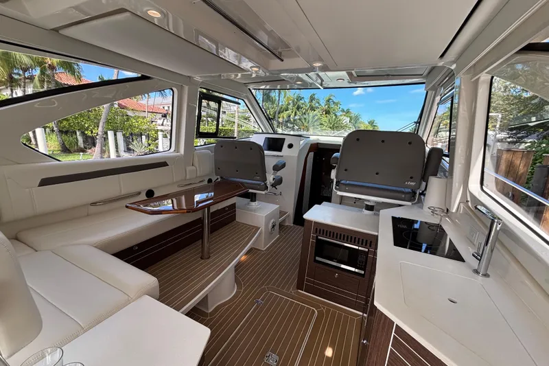 Slide: The Image of 2024 Pursuit OS 445 Offshore boat deck with open storage compartment. - 48