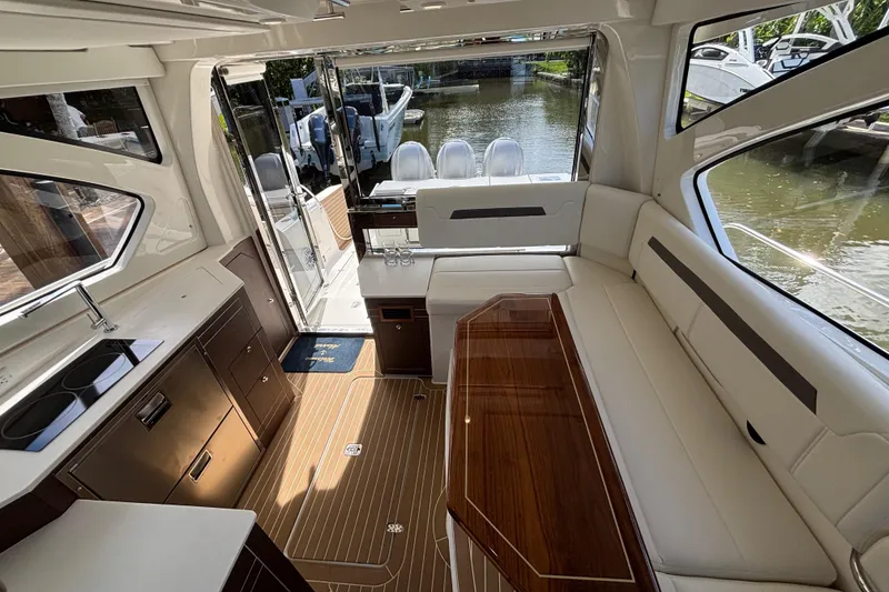 Slide: The Image of 2024 Pursuit OS 445 Offshore storage compartment with open hatch, showcasing interior space. - 56