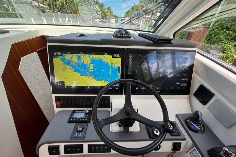 Slide: The Image of 2024 Pursuit OS 445 Offshore boat deck with rod holders and storage compartments. - 59