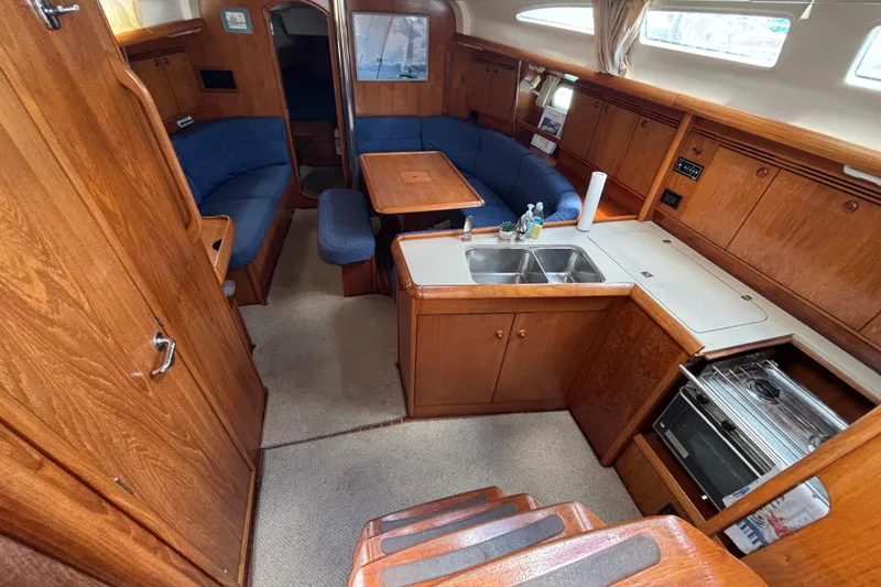 Slide: The Image of Interior of 2004 Jeanneau Sun Odyssey 40.3 yacht with kitchen and seating area. - 12