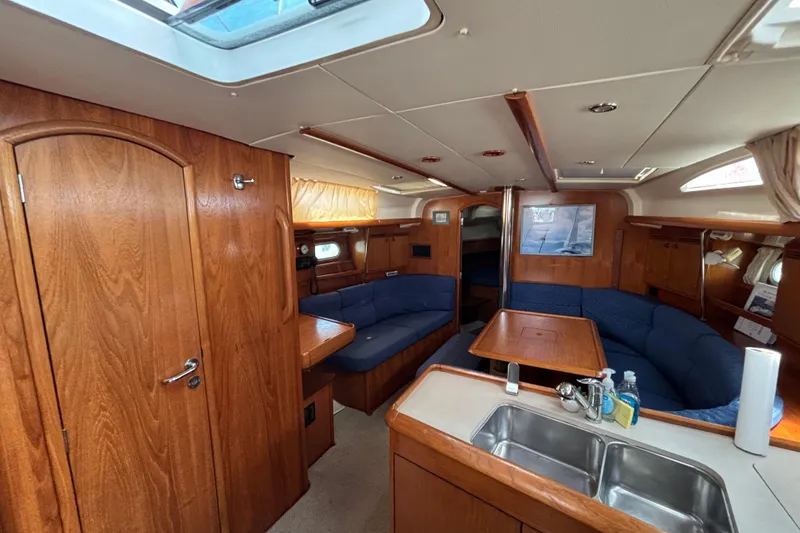 Slide: The Image of Interior of 2004 Jeanneau Sun Odyssey 40.3 yacht with wood finish and blue seating. - 15