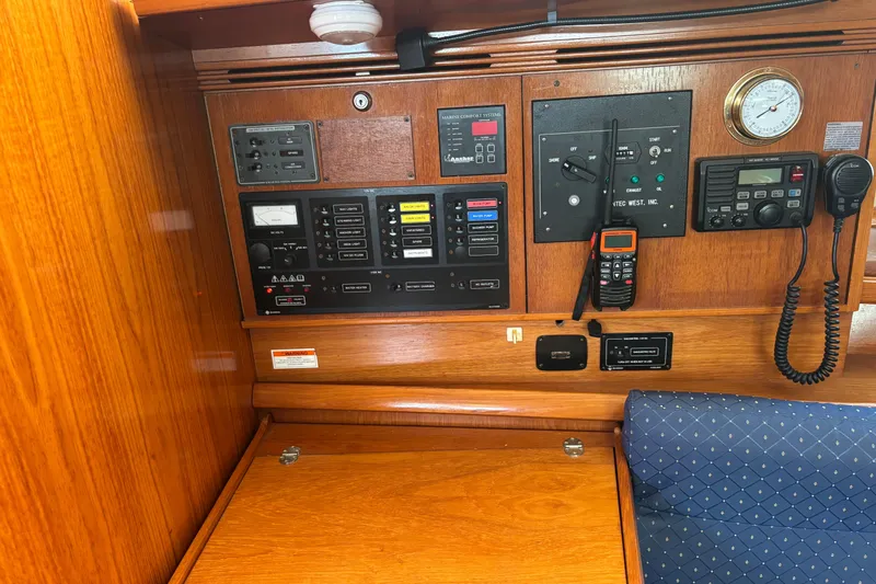 Slide: The Image of Control panel of a 2004 Jeanneau Sun Odyssey 40.3 sailboat, featuring navigation and communication equipment. - 16