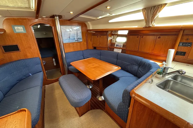 Slide: The Image of Interior of 2004 Jeanneau Sun Odyssey 40.3 yacht with cozy seating and wooden finishes. - 17