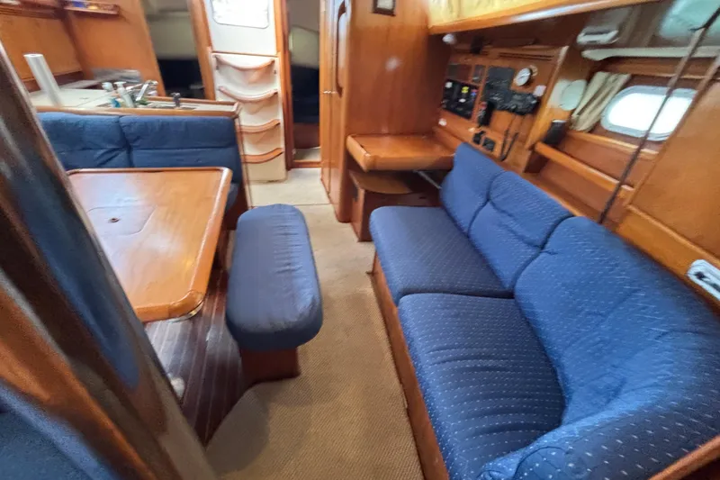Slide: The Image of Interior of 2004 Jeanneau Sun Odyssey 40.3 sailboat with blue seating and wooden finishes. - 22