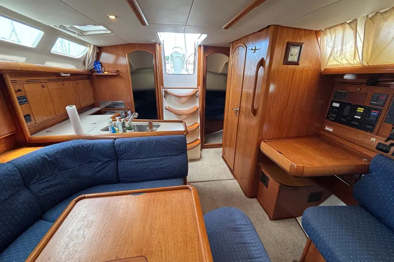 Slide: The Image of Interior of 2004 Jeanneau Sun Odyssey 40.3 sailboat with wood finish and blue seating. - 23