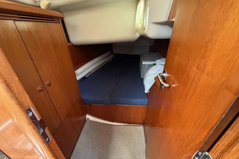 Slide: The Image of Cozy cabin interior of 2004 Jeanneau Sun Odyssey 40.3 sailboat with wooden finish. - 25