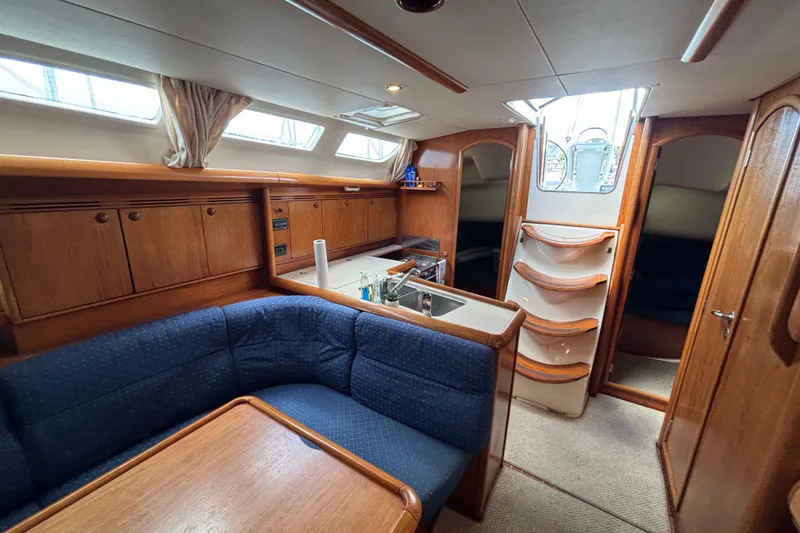 Slide: The Image of Interior of 2004 Jeanneau Sun Odyssey 40.3 sailboat with cozy seating and wooden cabinetry. - 29