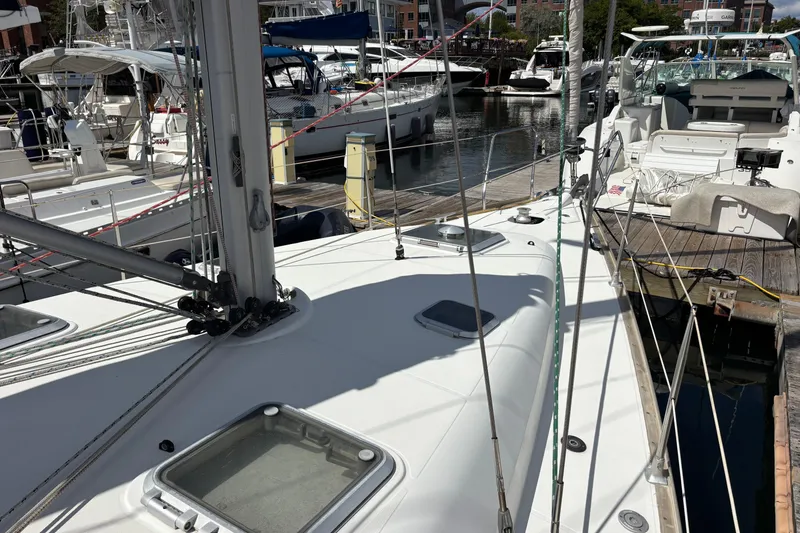 Slide: The Image of 2004 Jeanneau Sun Odyssey 40.3 sailboat docked at marina, showcasing deck and rigging. - 33