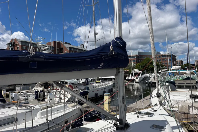 Slide: The Image of Jeanneau Sun Odyssey 40.3 sailboat docked at marina, 2004 model, clear sky background. - 34