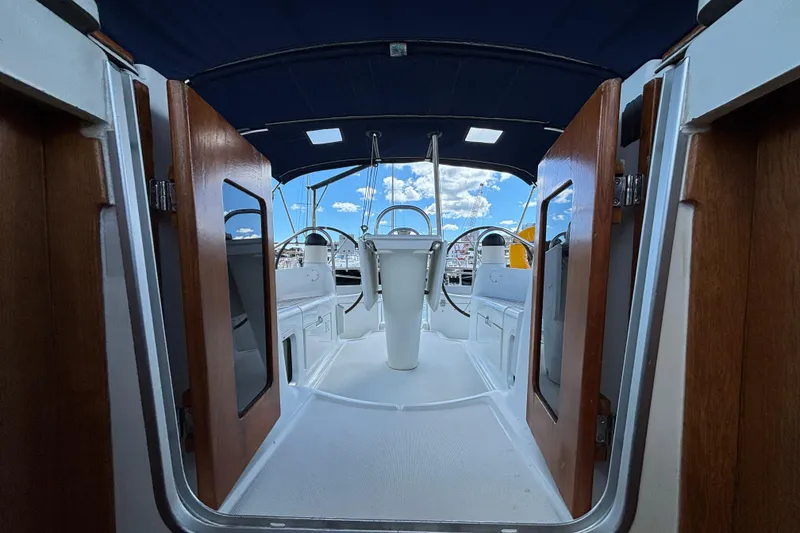 Slide: The Image of Interior view of 2004 Jeanneau Sun Odyssey 40.3 sailboat cockpit with wooden doors. - 37