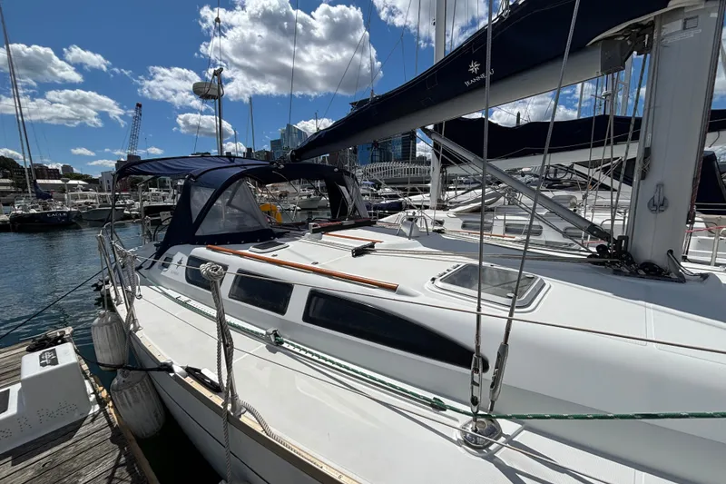 Slide: The Image of 2004 Jeanneau Sun Odyssey 40.3 sailboat docked at marina under blue sky. - 4