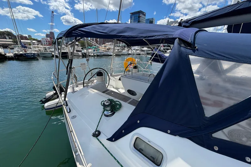 Slide: The Image of 2004 Jeanneau Sun Odyssey 40.3 sailboat docked in marina under blue sky. - 6
