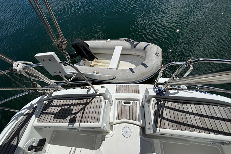 Slide: The Image of 2004 Jeanneau Sun Odyssey 40.3 yacht deck with inflatable dinghy on water. - 8