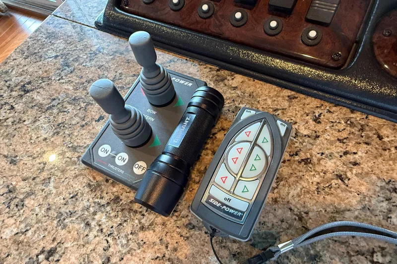 Slide: The Image of Control panel and remote on 2008 Sumerset Luxury HouseBoat, featuring thruster controls. - 100