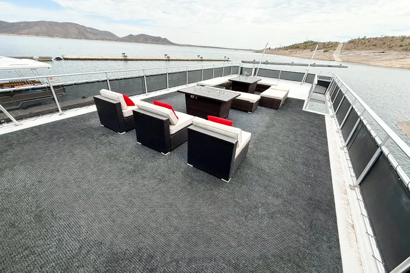 Slide: The Image of Luxurious 2008 Sumerset houseboat deck with stylish outdoor seating and scenic water views. - 11