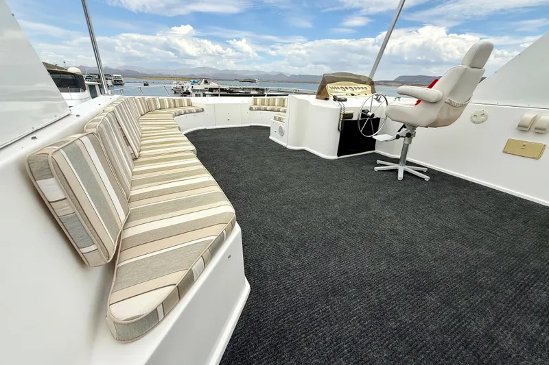 Slide: The Image of Luxurious 2008 Sumerset houseboat deck with striped seating and captain's chair. - 14