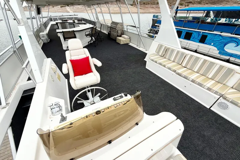 Slide: The Image of Luxurious 2008 Sumerset houseboat interior with seating, helm, and scenic lake view. - 15