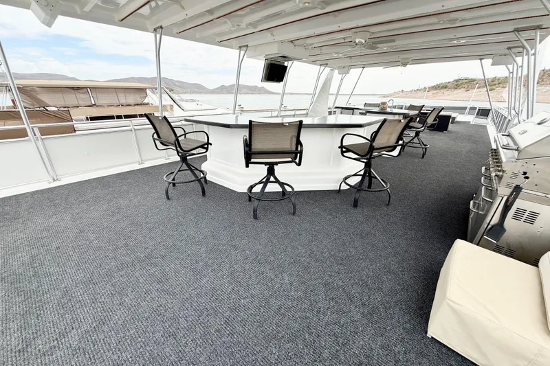 Slide: The Image of Luxurious 2008 Sumerset houseboat deck with bar seating and scenic views. - 17