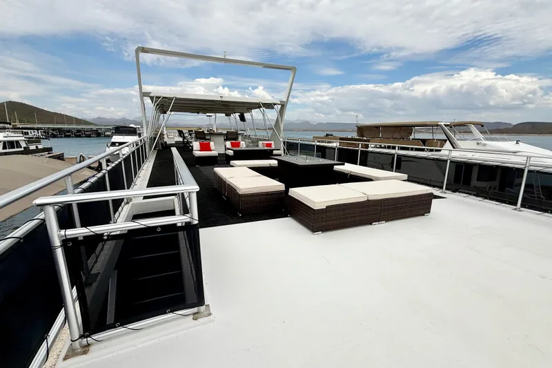 Slide: The Image of Luxurious 2008 Sumerset houseboat deck with modern seating and scenic water views. - 18