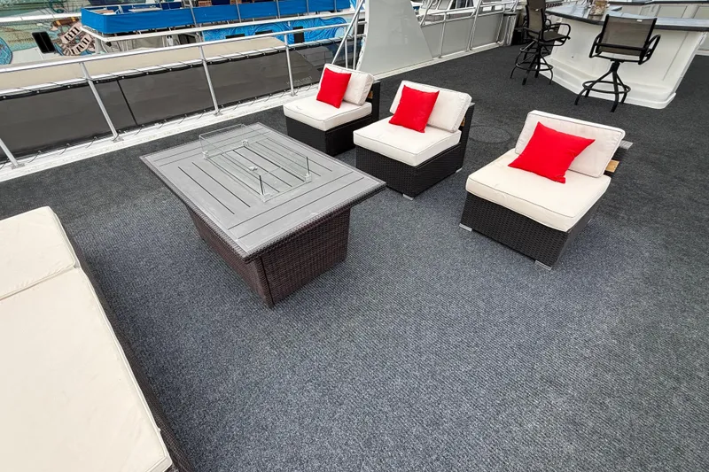 Slide: The Image of Luxurious 2008 Sumerset houseboat deck with modern seating and vibrant red cushions. - 20