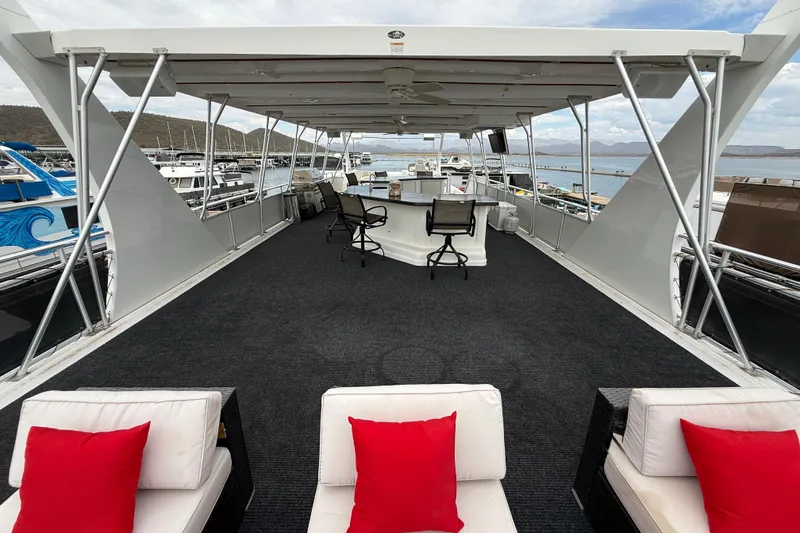 Slide: The Image of Luxurious 2008 Sumerset houseboat deck with seating, red cushions, and marina view. - 22