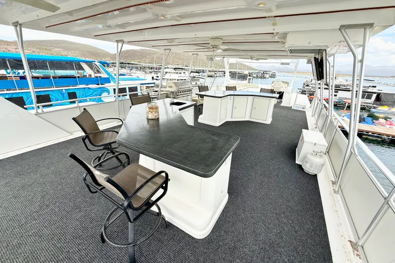 Slide: The Image of Luxurious 2008 Sumerset houseboat deck with seating, bar, and marina view. - 24