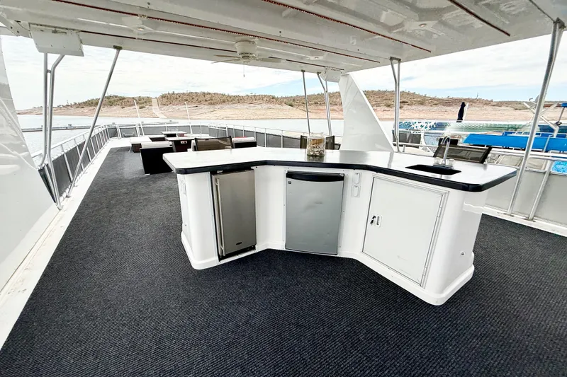 Slide: The Image of Luxurious 2008 Sumerset houseboat deck with outdoor bar and scenic water views. - 27