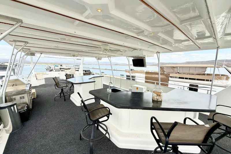 Slide: The Image of Luxurious 2008 Sumerset houseboat deck with bar, seating, and scenic water views. - 29