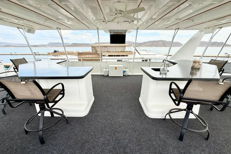 Slide: The Image of Luxurious 2008 Sumerset houseboat interior with bar seating and scenic water views. - 30