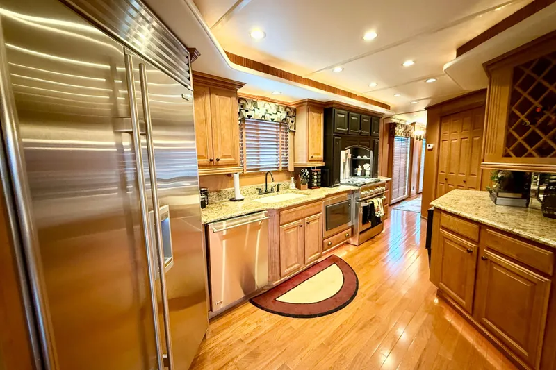 Slide: The Image of Luxurious kitchen interior of 2008 Sumerset HouseBoat, featuring modern appliances and wooden cabinetry. - 39