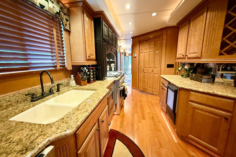 Slide: The Image of Luxurious kitchen interior of 2008 Sumerset HouseBoat with granite countertops and wooden cabinetry. - 42